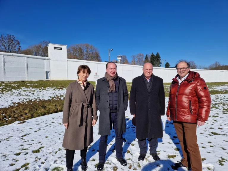 Vier Personen vor der Mauer des Deutsch-Deutschen Museums im Schnee