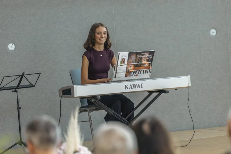 Junge Frau spielt Keyboard auf der Bühne vor Publikum bei der Preisverleihung